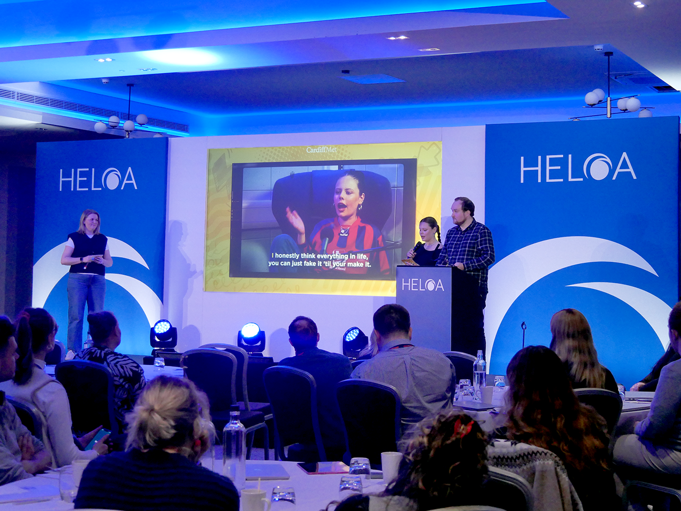 Three members of Cardiff Metropolitan University presenting with an image of a podcast on the screen behind