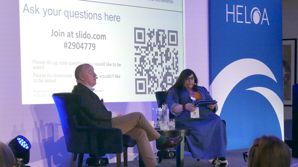 An image of Professor Ken Sloan and Reena Littlehales on a stage